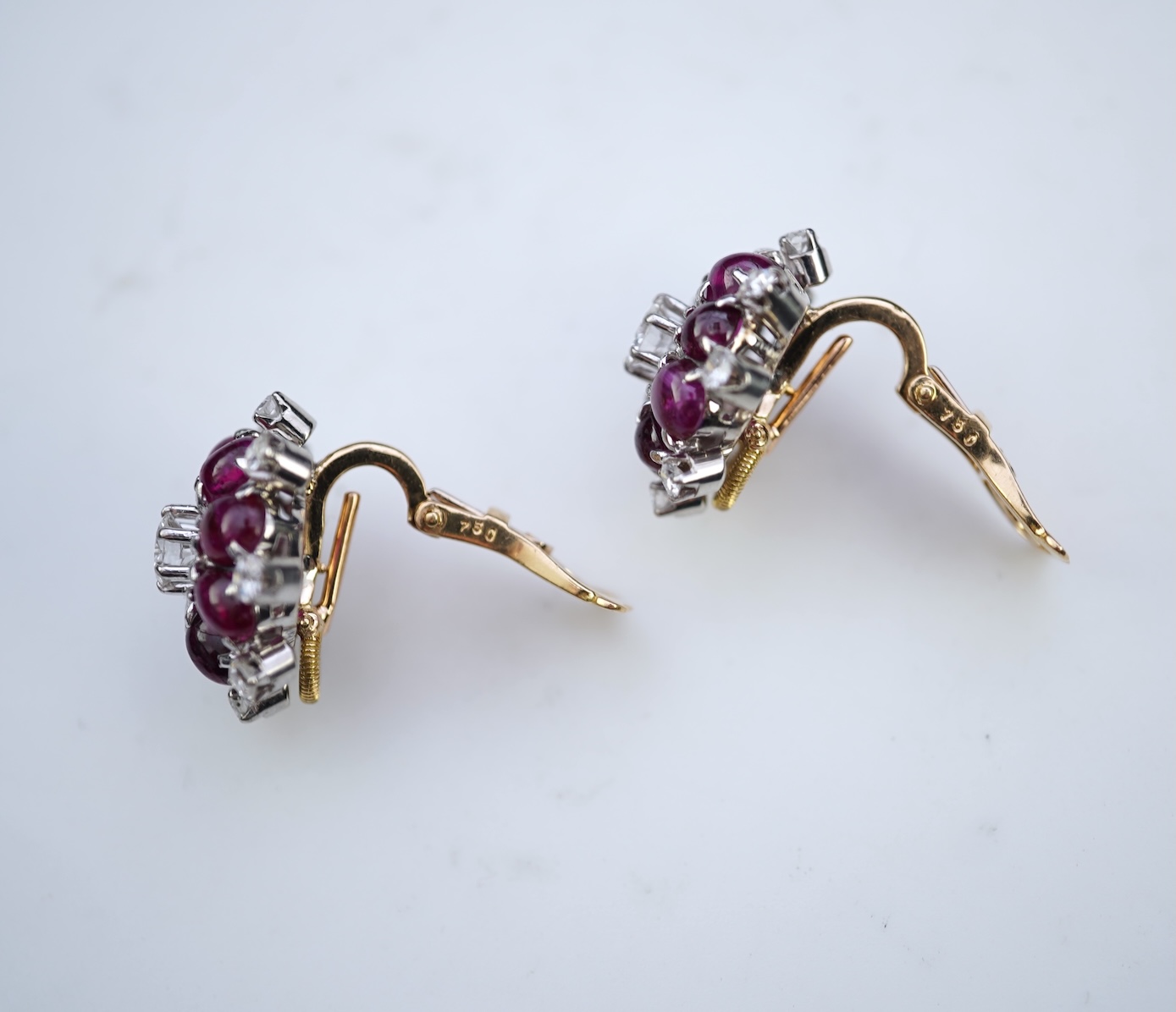 A pair of ruby and diamond ear clips, mid 20th century